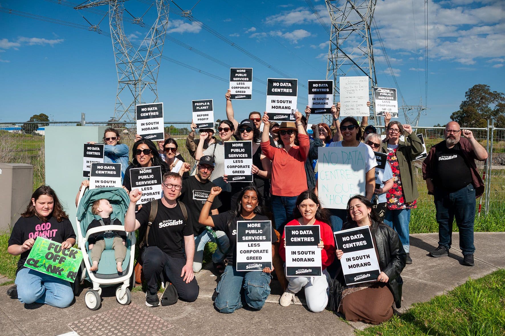 A group of protesters hold placards opposing data centre construction in South Morang